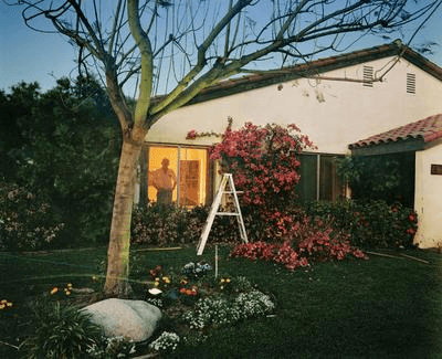 Larry Sultan domestic photography reference showing a person working outside a home