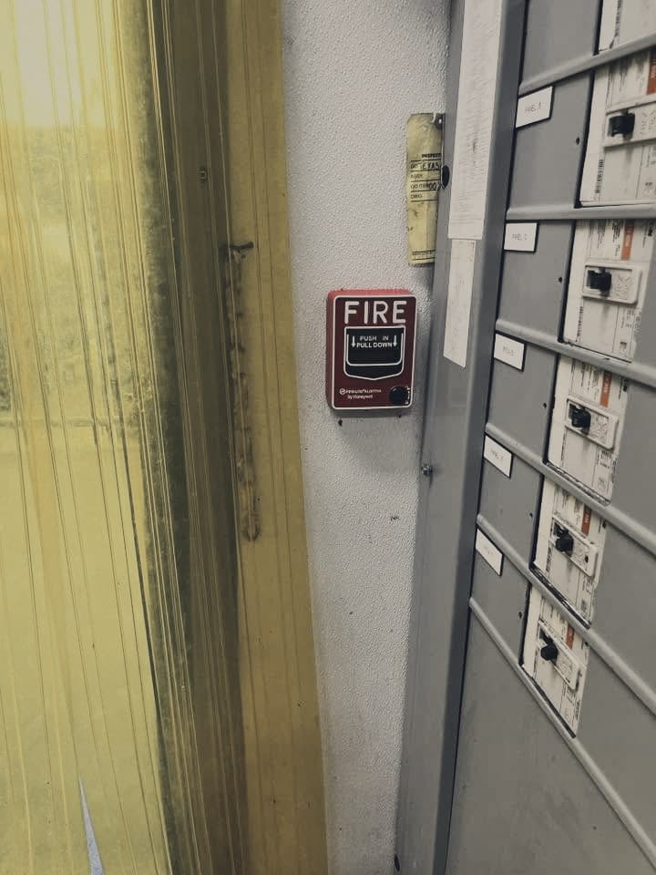 Pull station beside electrical panels